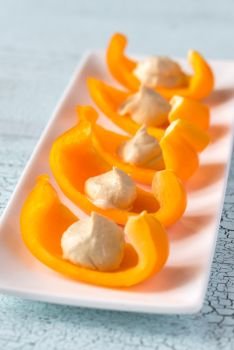 Slices of bell pepper with hummus