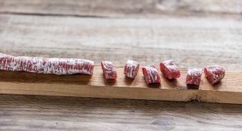 Cut spanish salami on the wooden board