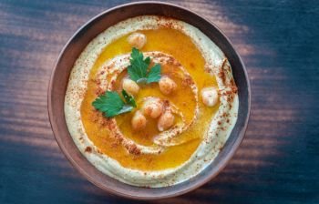 Bowl of hummus on the wooden table