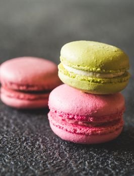 Colorful macarons on the dark background