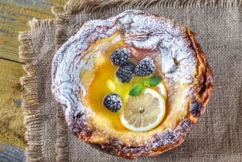 Dutch Baby pancake served with melted butter and fresh berries