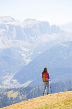 girl hiker at the mountains Dolomites and views of the valley, Italy. Seceda
