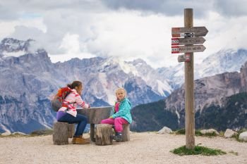 two sisters girls hikers at the mountains Dolomites, Italy. Cinque Torri
