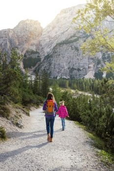 family. mother and her daughter walking around the Braies lake, Dolomites Italy
