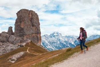 girl hiker at the mountains Dolomites, Italy. Cinque Torri
