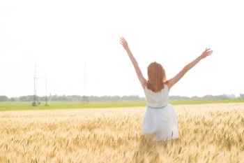 happy summer and freedom. Beautiful girl at the wheat field on a sunny day
