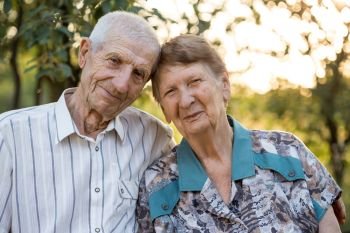 smiling grandparents. portrait of smiling senior man and senior woman at the garden. happy old age
