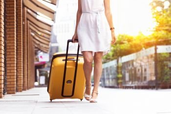 girl traveler and her yellow  luggage. wonderful travel
