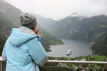 girl at viewpoint looking at the Geiranger fjord
