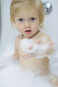 little baby girl covered with a soap at the bath
