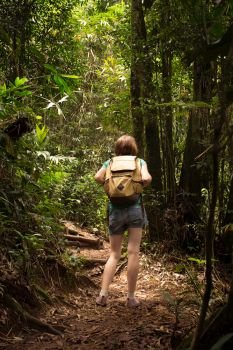 girl hiker with backpack at the jungle forest
