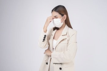 portrait of young businesswoman wearing a surgical mask over white background studio
