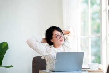 Happy Stretching Relaxation Resting of asian freelance people business female casual working with laptop computer with coffee cup and smartphone in coffee shop the background,communication concept