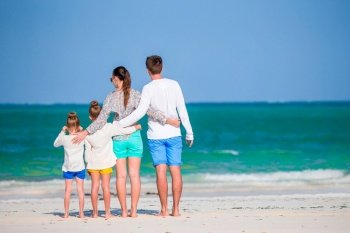 Young family on beach vacation together. Young family on vacation on the beach