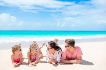 Happy beautiful family on white beach having fun. Young family on vacation having fun