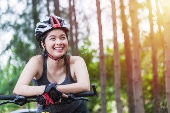Beautiful young female woman helmet activity bicycle at forest on summer with copy space