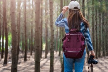 Female woman lifestyle use camera photographer travel taking shooting photo in forest nature and backpack and copy space