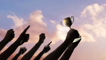 Teamwork, Winning, Goal and Successful Concept.  Silhouette of People Raise Up Hands into the Sky. the Leader Holding a Golden Trophy. Cheerful Gesture Hand