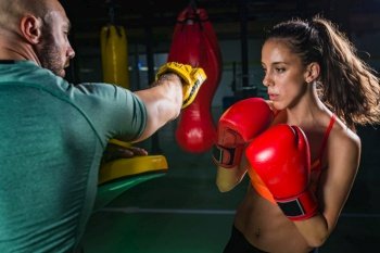 Female on boxing class with her male instructor