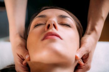 Cranial osteopathy massage. Therapist massaging woman’s head.. Cranial Osteopathy. Therapist Massaging Woman’s Head.
