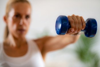 Woman Exercising with Dumbbells. Exercise for Shoulders.