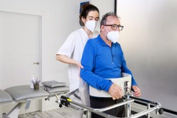 Physiotherapist assisting a patient with Amyotrophic Lateral Sclerosis. High quality photo. Physiotherapist assisting a patient with Amyotrophic Lateral Sclerosis.