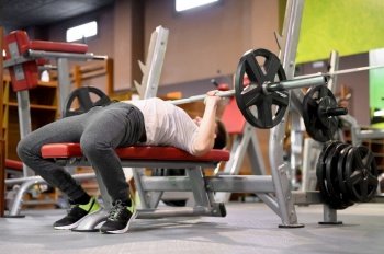 Young Man Doing Bench Press Workout In Gym. High quality photo. Young Man Doing Bench Press Workout In Gym