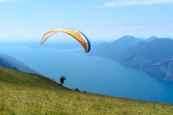 Paragliders in the air over the mountains of lake garda in italy summer