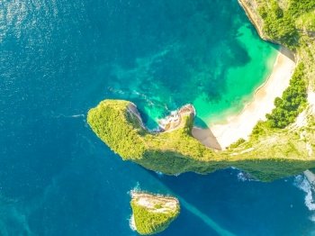 Rocky coast of a tropical island. Empty beach and small island. Sunny weather. Aerial view. Peninsula with an Empty Beach and a Small Island. Aerial View