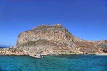Sea view on the coast of the Gramvousa island with fortress on the top, Crete, Greece