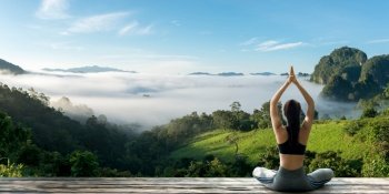 Young woman practicing yoga in the nature.female happiness. Landscape background