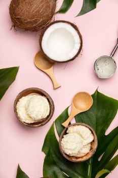 Creative flat lay with coconut ice cream and tropical plants on pink background. Creative flat lay with coconut ice cream and tropical plants