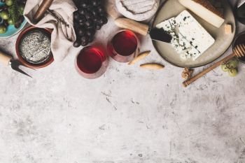 Red wine with charcuterie assortment on rustic concrete background, flat lay, copyspace