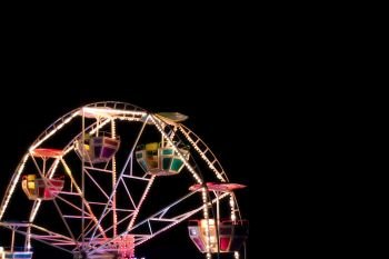 Ferris wheel in a night park. Entertainment in the carnival park.
