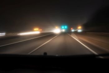 Fast night driving on highway, view from inside of a car