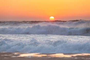 Sunset over the ocean. Panorama of ocean waves and setting sun. Florida, USA