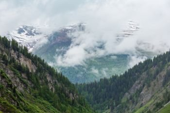 Passo del San Gottardo or St. Gotthard Pass summer misty landscape (Switzerland). Rainy weather