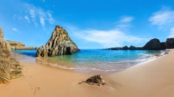 Summer sandy Mexota beach and pointed rock near (Spain). Atlantic Ocean coastline landscape. Three shots stitch image.