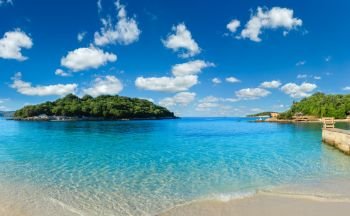 Beautiful Ionian Sea with clear turquoise water and morning summer coast. View from Ksamil beach, Albania.Two shots stitch panorama.