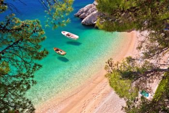 Hiden beach in Brela with boats on emerald sea aerial view, Makarska riviera of Dalmatia, Croatia