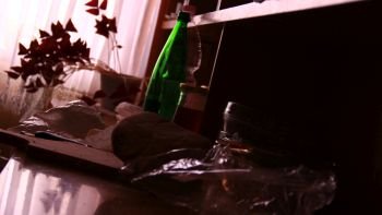 Green bottle and glass on the table as alcohol problem concept