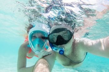 A couple in love taking selfie underwater in Indian Ocean, Maldives. Clear turquoise water.. A couple in love taking selfie underwater in Indian Ocean, Maldives