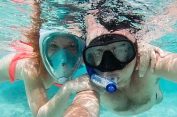 A couple in love taking selfie underwater in Indian Ocean, Maldives. Clear turquoise water.. A couple in love taking selfie underwater in Indian Ocean, Maldives
