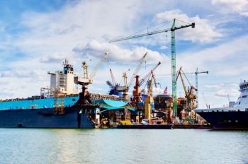 Shipyard. Ship under construction, repair. Industrial machinery, crane. Transport.. Shipyard. Ship under construction, repair. Industrial, transport.