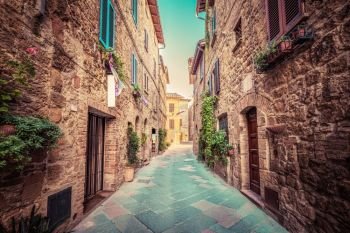 Charming narrow street in an old Italian town of Pienza. Tuscany, Italy. Vintage. Narrow street in an old Italian town of Pienza. Tuscany, Italy. Vintage