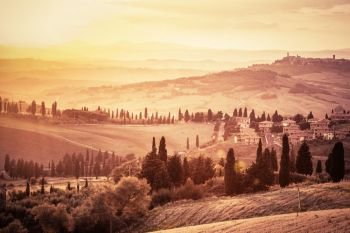 Wonderful Tuscany countryside landscape with cypress trees, farms and small medieval towns, Italy. Vintage sunset. Wonderful Tuscany landscape with cypress trees, farms and small medieval towns, Italy. Vintage sunset