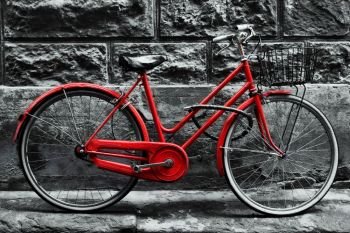 Retro vintage red bike on black and white wall. Old charming bicycle concept.. Retro vintage red bike on black and white wall. 