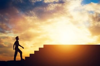 Man standing in front of stairs. Aspiration and ambition. Overcoming obstacles.. Silhouette of a man standing in front of stairs.