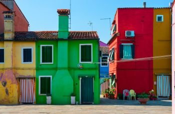 Facades of colorful houses on Burano island in summer