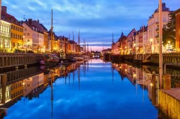 Panorama of Nyhavn with colorful facades of old houses and old ships in the Old Town of Copenhagen, capital of Denmark.. Panorama of Nyhavn in Copenhagen, Denmark.